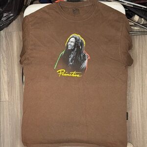 Primitive Brown Graphic Tee with Iconic Design